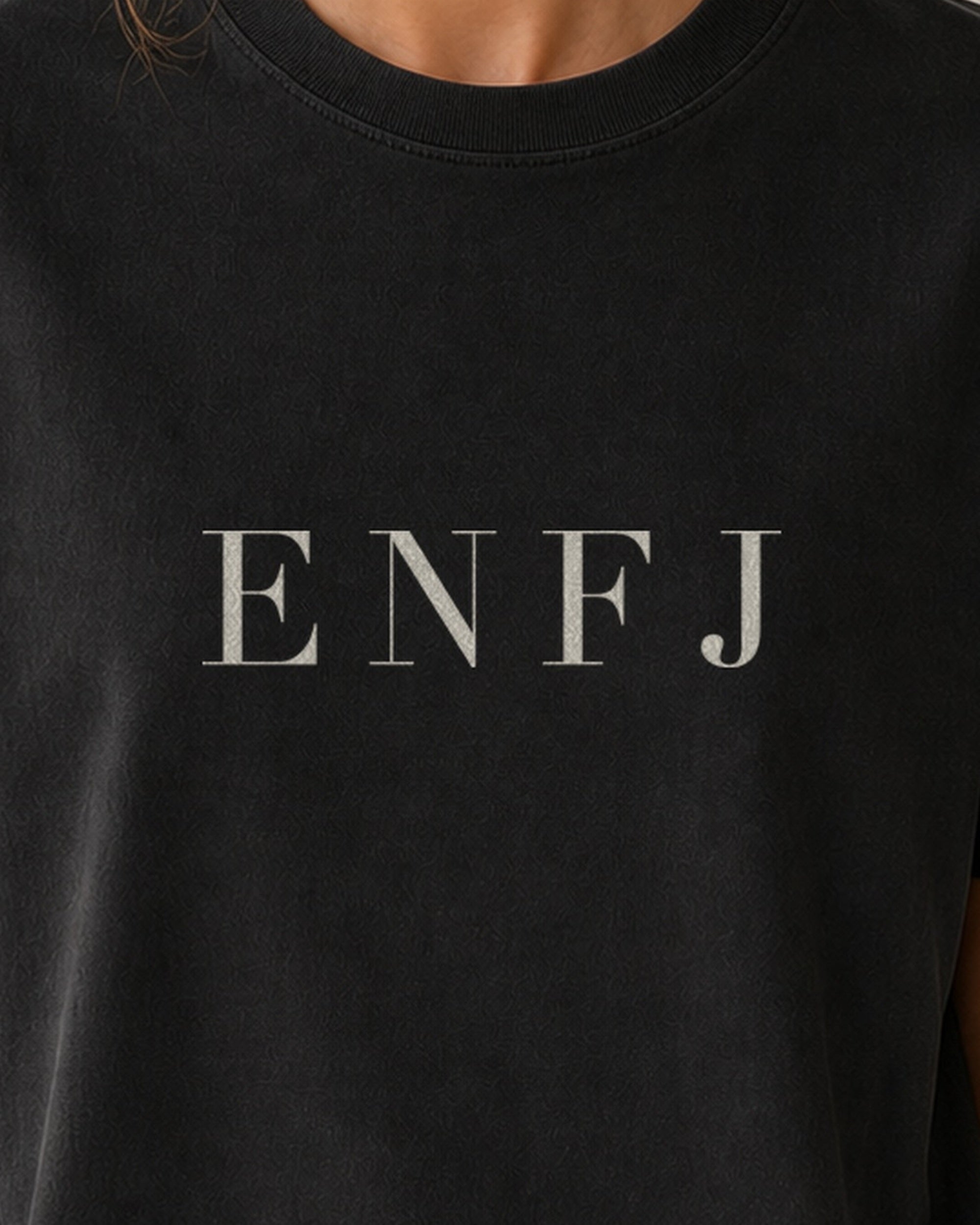 The Typese ENFJ Comfort Colors Tee in black, female front detail