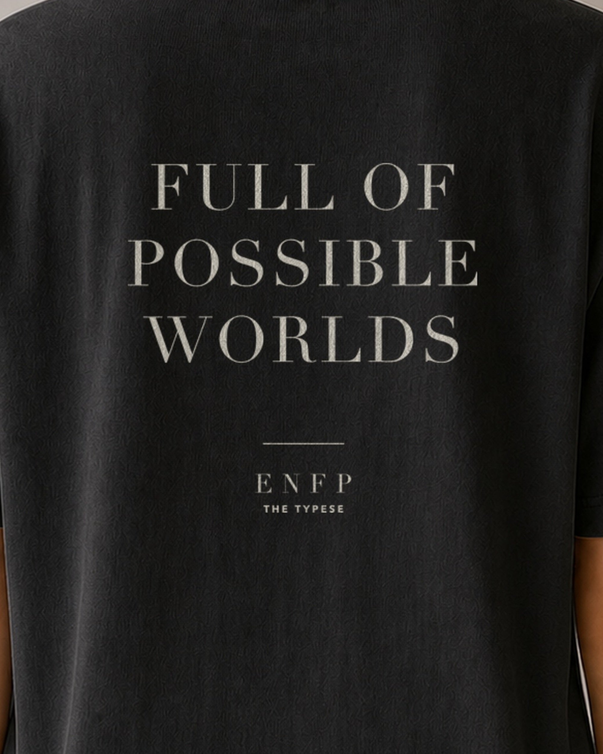 The Typese ENFP Comfort Colors Tee in black, female back detail