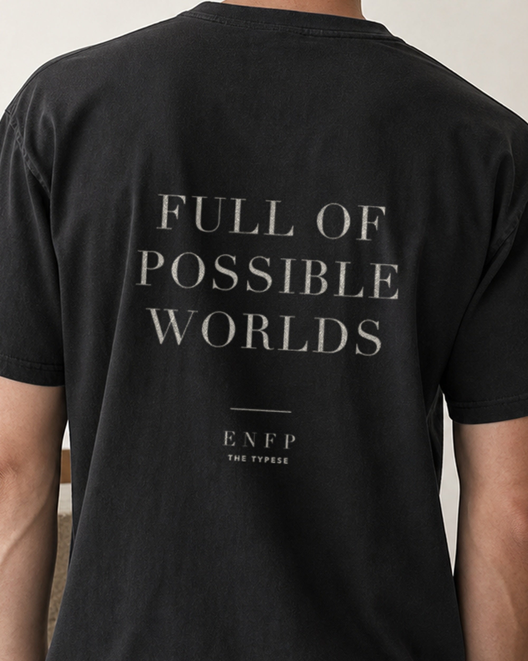 The Typese ENFP Comfort Colors Tee in black, male back detail