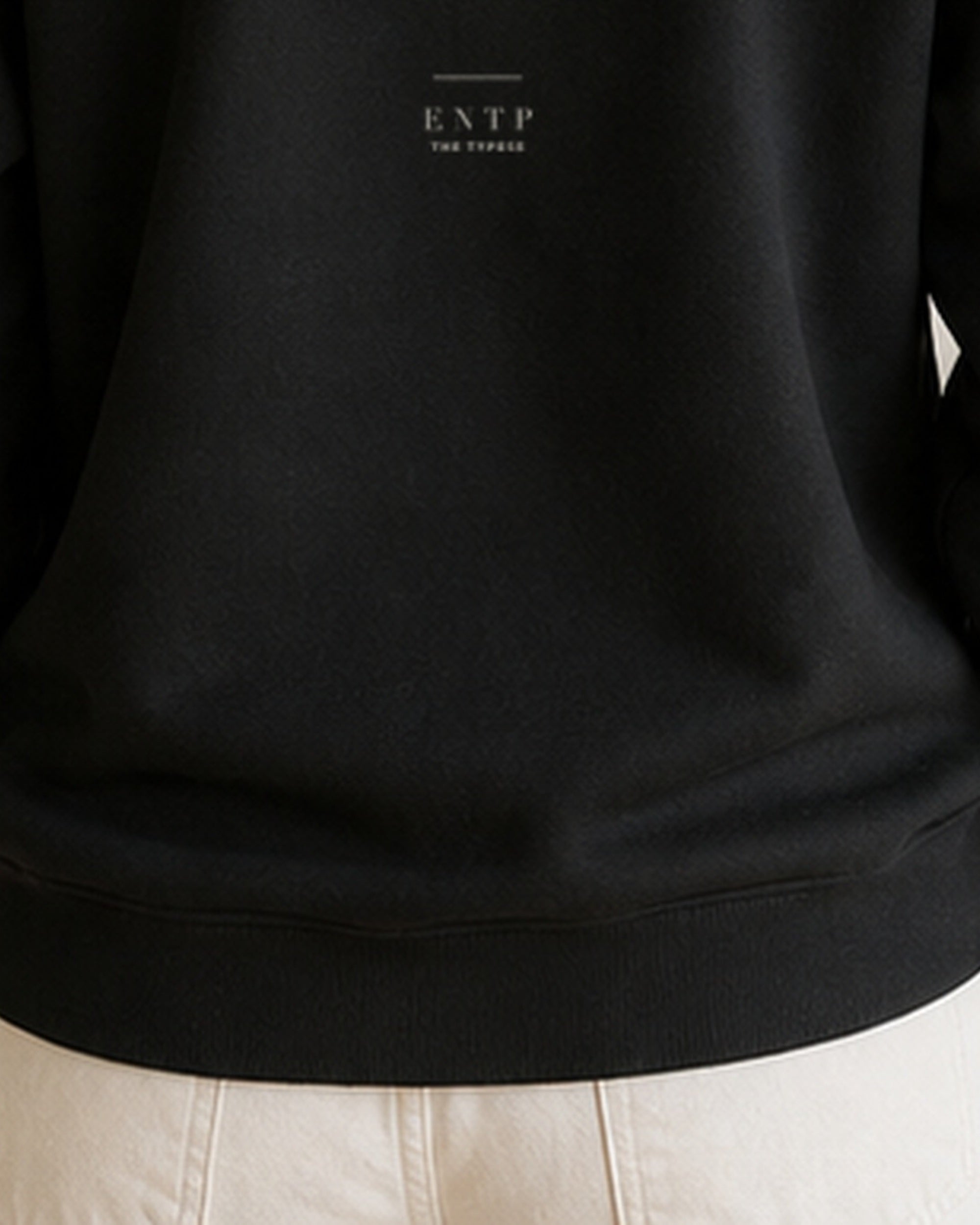 The Typese ENTP Gildan crewneck sweatshirt in black, female back hem fleece texture