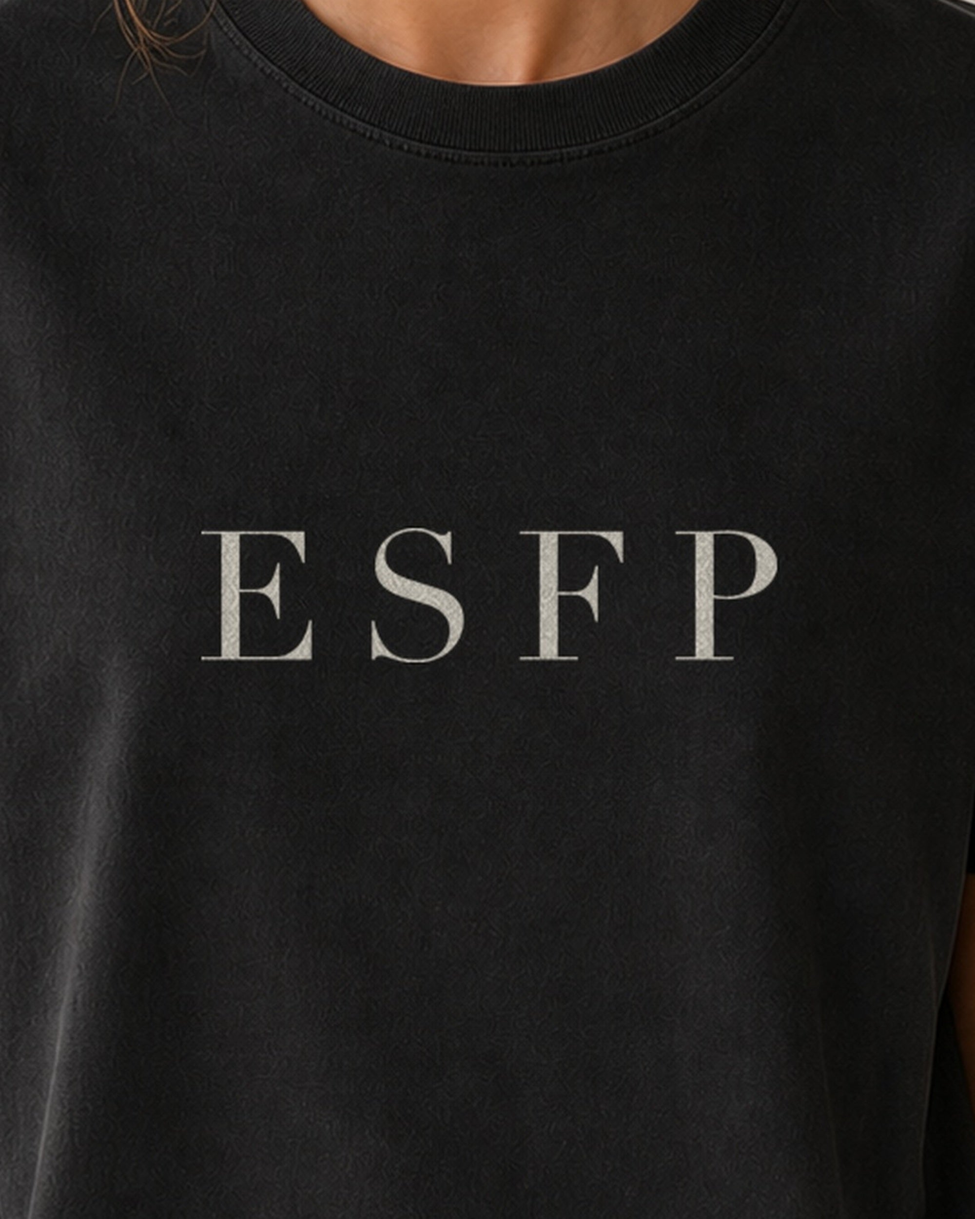 The Typese ESFP Comfort Colors Tee in black, female front detail