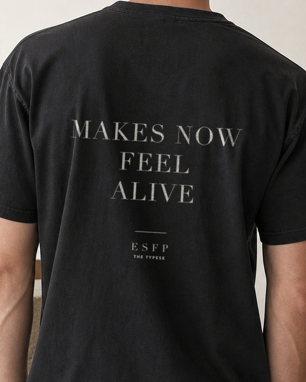 The Typese ESFP Comfort Colors Tee in black, male back detail