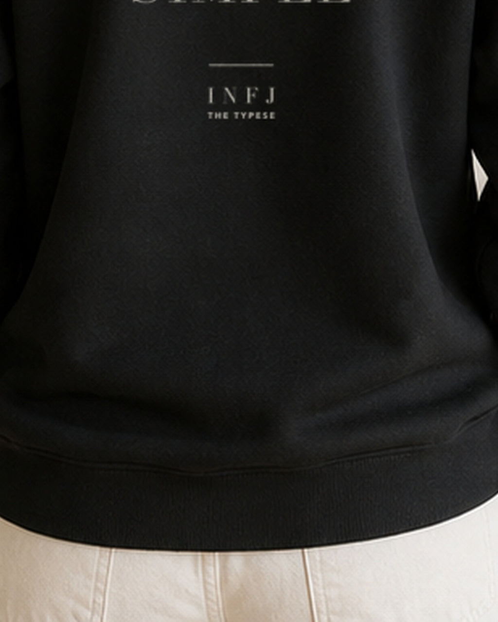The Typese INFJ Gildan crewneck sweatshirt in black, female back hem fleece texture