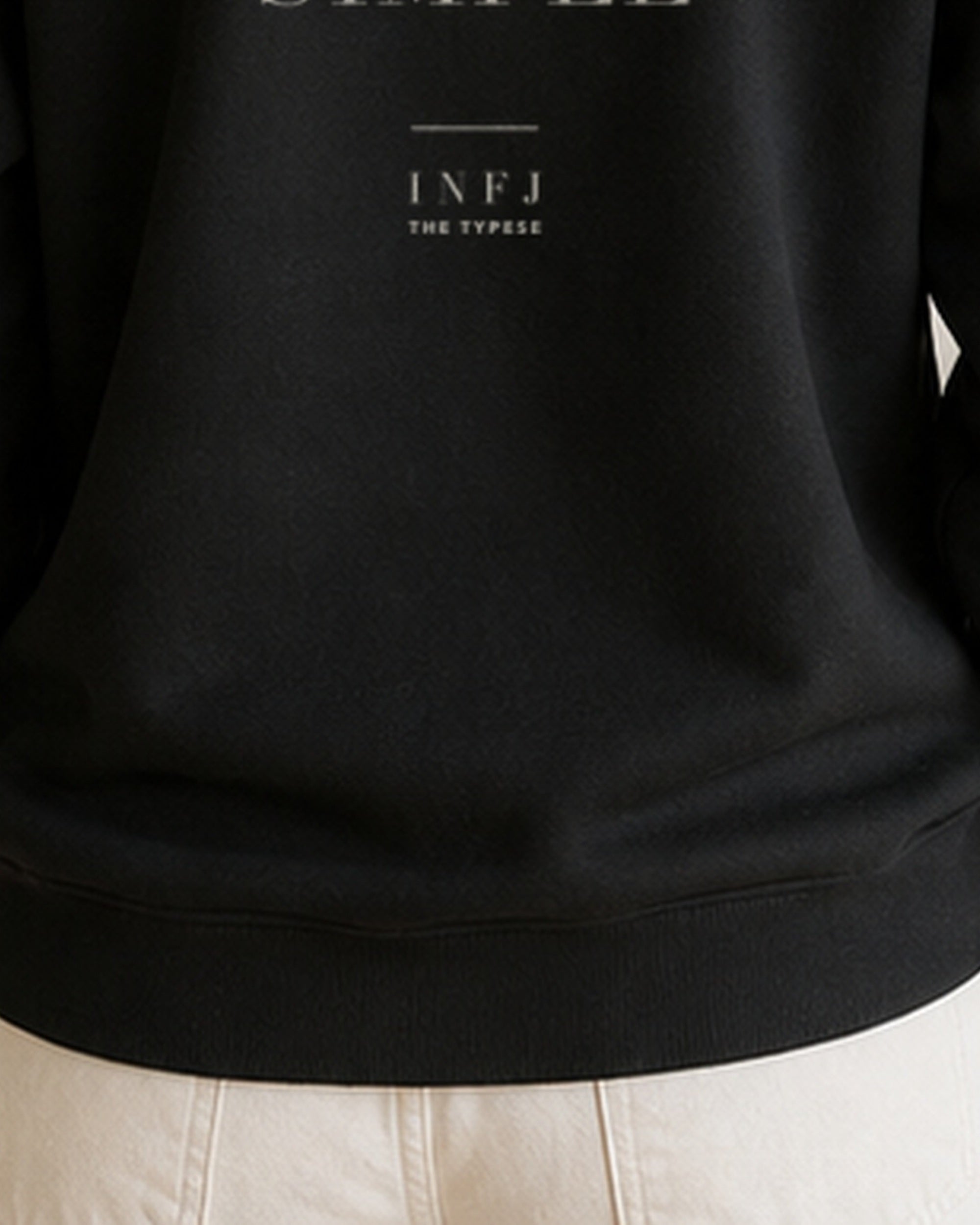 The Typese INFJ Gildan crewneck sweatshirt in black, female back hem fleece texture