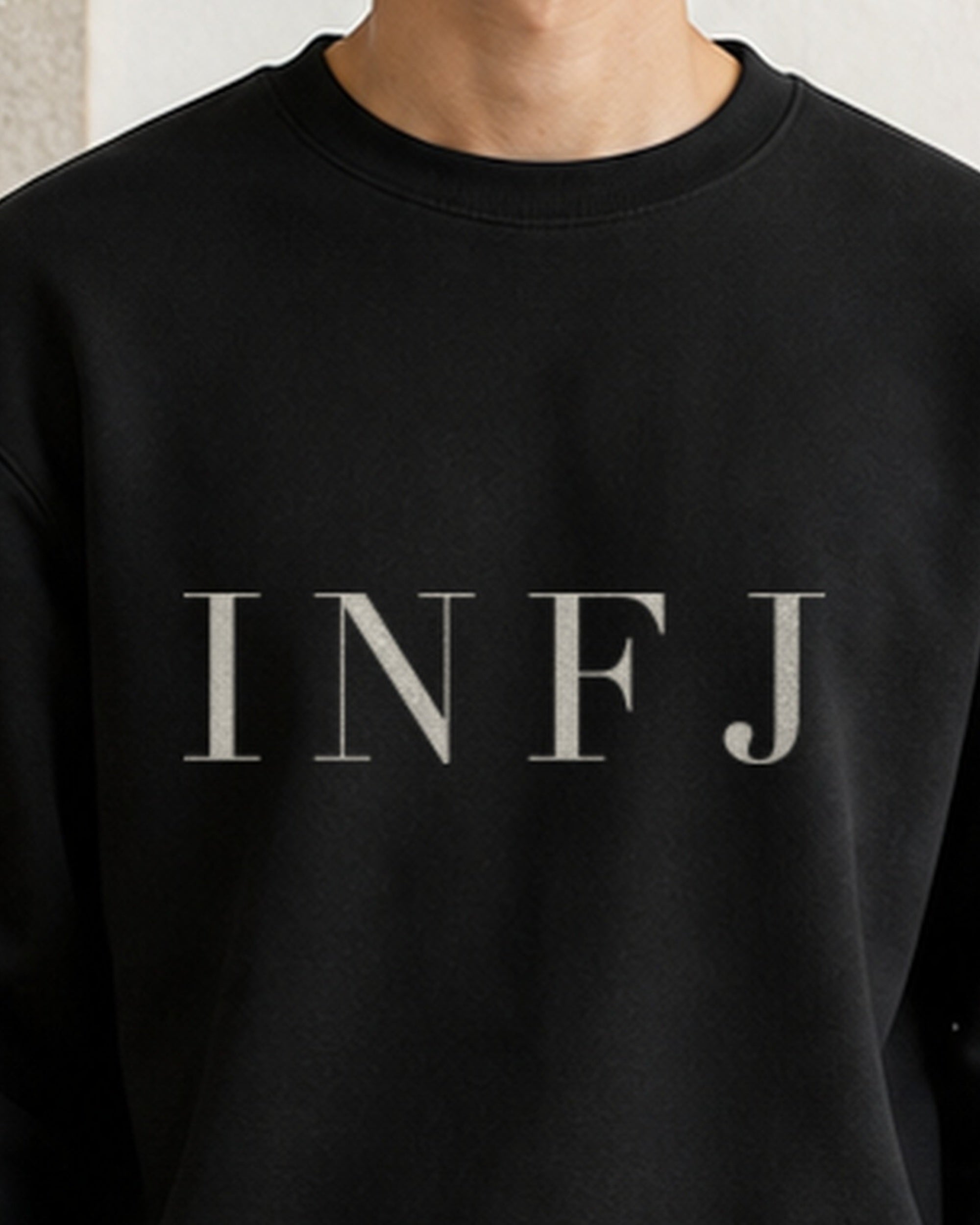The Typese INFJ Gildan crewneck sweatshirt in black, male front neckline fabric