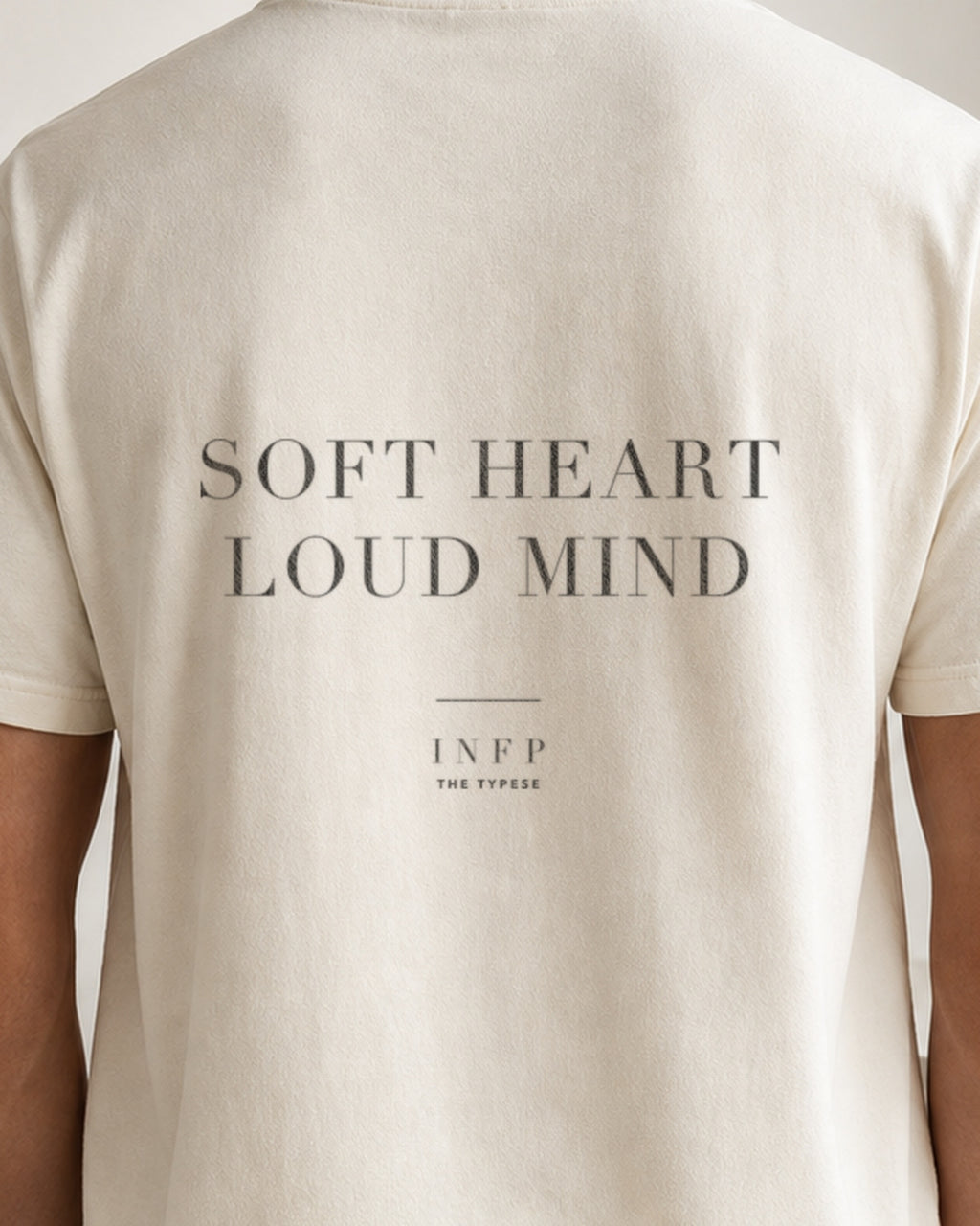 The Typese INFP Comfort Colors Tee in cream white, male back detail