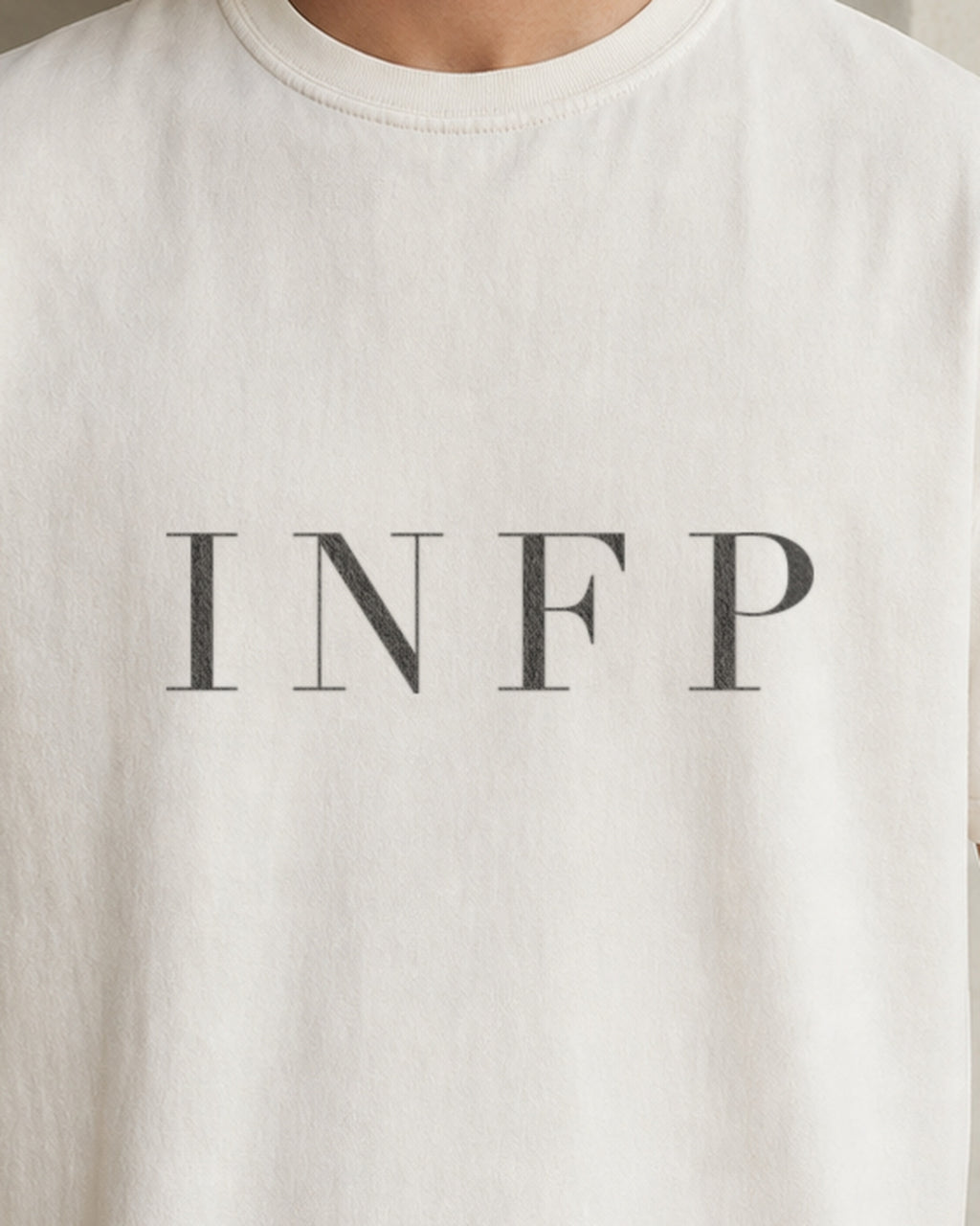 The Typese INFP Comfort Colors Tee in cream white, male front detail