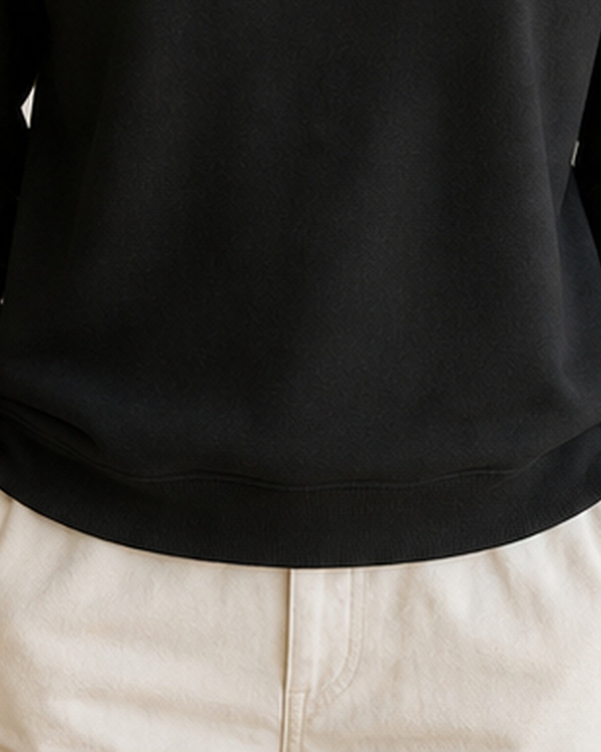 The Typese INTJ Gildan crewneck sweatshirt in black, female front hem fleece texture