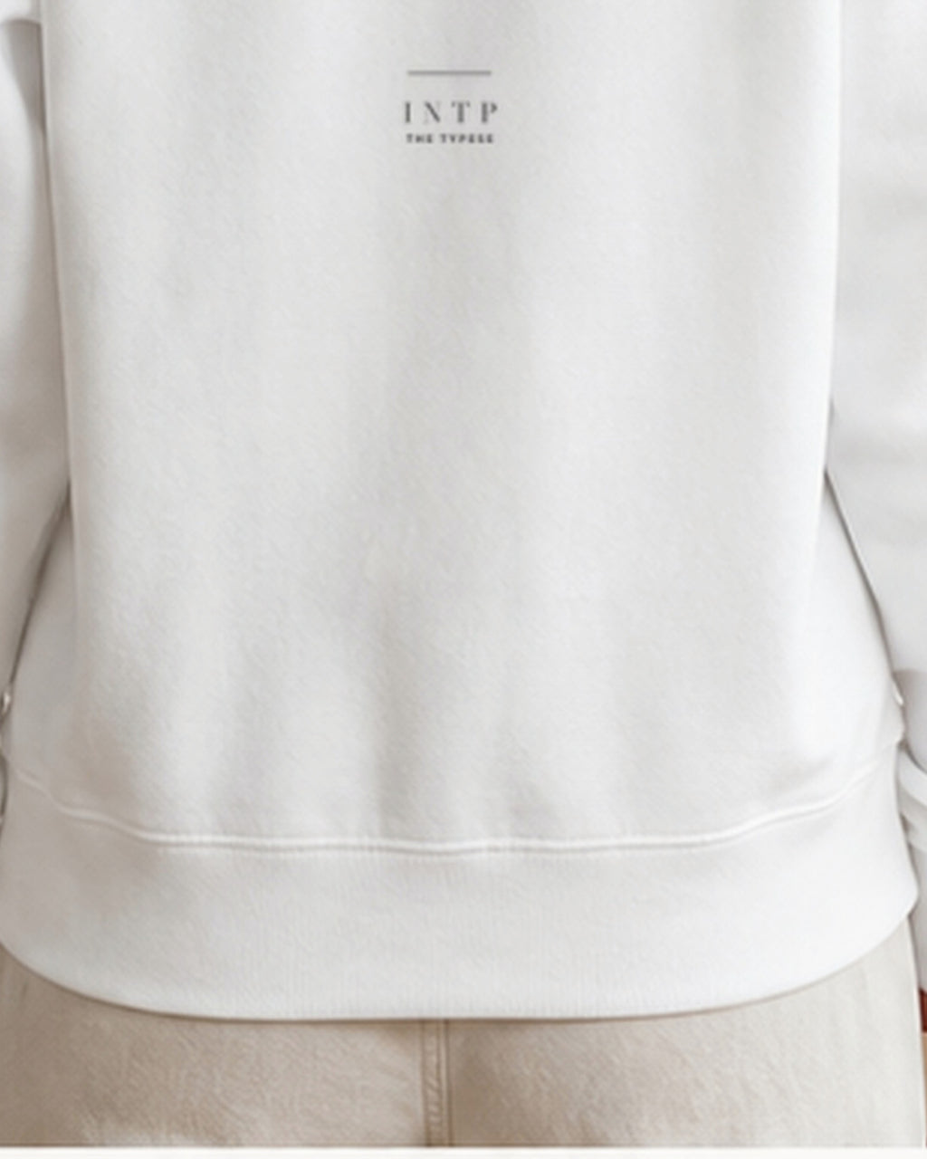 The Typese INTP Gildan crewneck sweatshirt in white, female back hem fleece texture v7