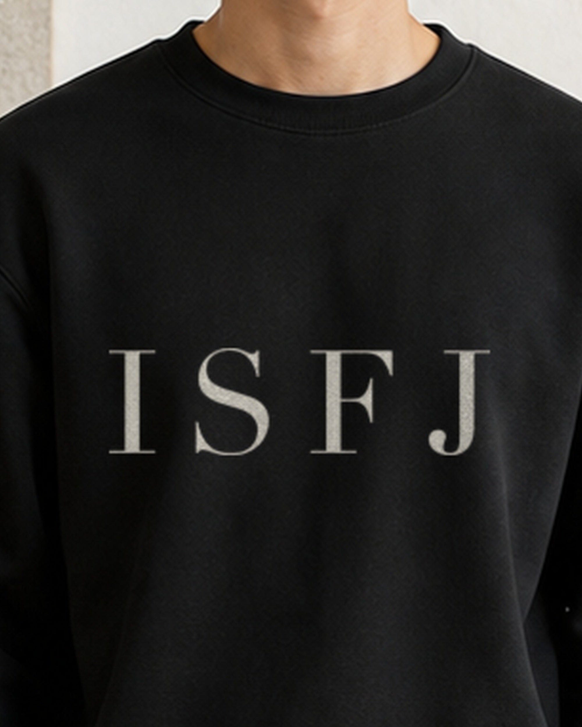 The Typese ISFJ Gildan crewneck sweatshirt in black, male front neckline fabric