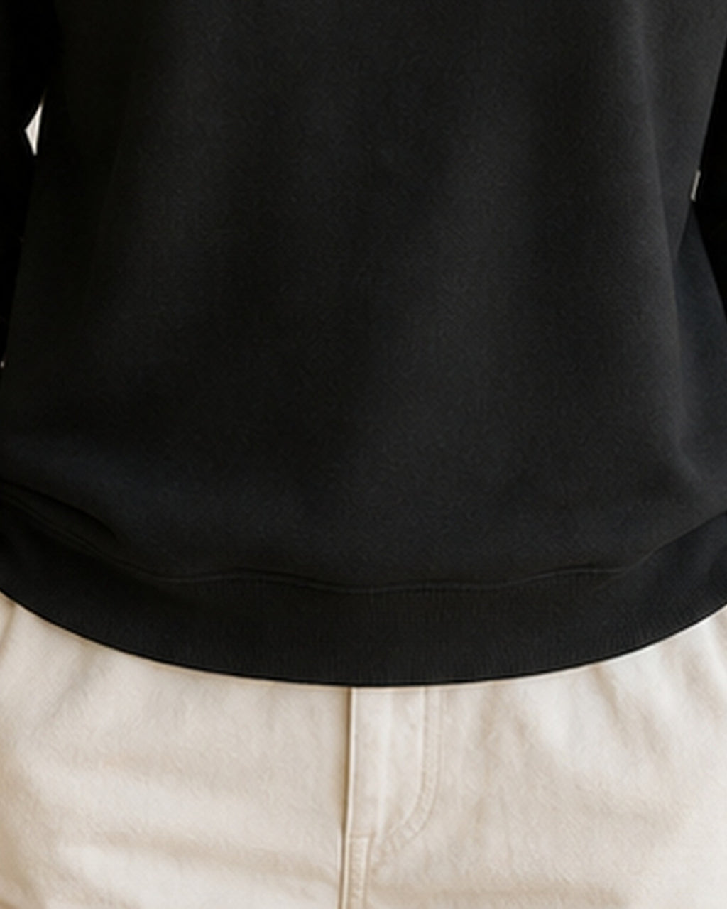 The Typese ISFP Gildan crewneck sweatshirt in black, female front hem fleece texture